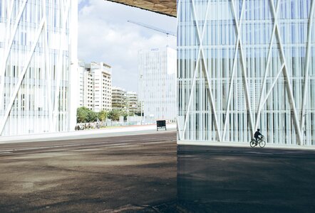 Cyclist By Modern Building photo