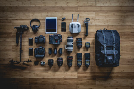 Diverse Personal Photographer Equipment Laying on the Wooden Floor photo