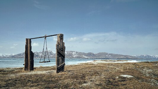 Empty Wooden Rural Swing in Scenic Mountain Landscape photo