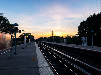 Sunset Over Train Platform and Tracks photo