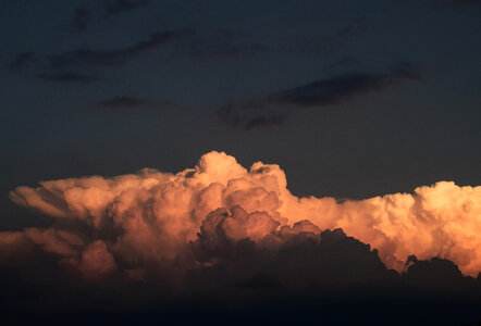 Cumulus Clouds against Dark Sky photo