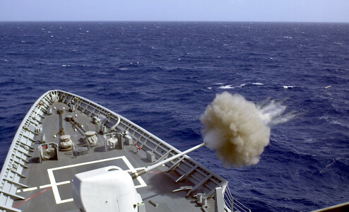 Fires its 5 inch gun at a target drone during a gun exercise photo
