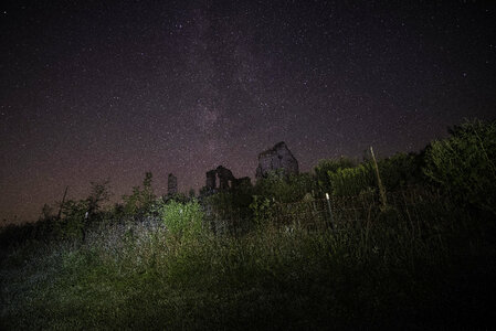 Stars coming from above the old abandoned house photo
