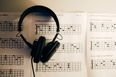 Music Sheets and Headphones on Table photo