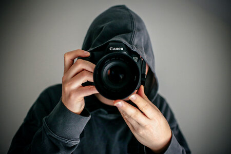 Guy in the Hood with Canon DSLR Camera photo