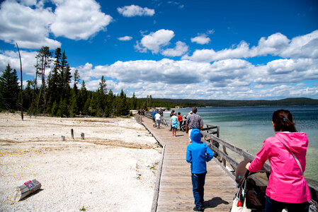People on the walkway under the clouds by Yellowstone Lake