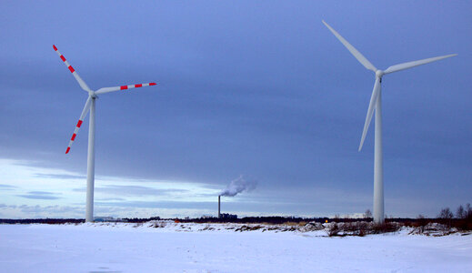 wind turbine blades in snow covered winter field photo