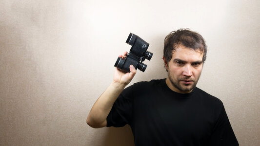 young man with binoculars photo