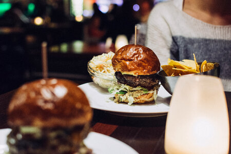 Celebrating with a juicy beef burger in a restaurant photo