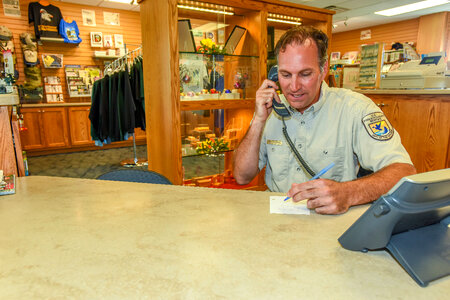 FWS Staffer at visitor center desk on phone-3