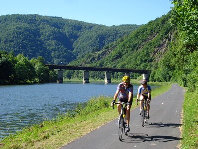 Happy carefree mountain bike couple cycling outdoors photo
