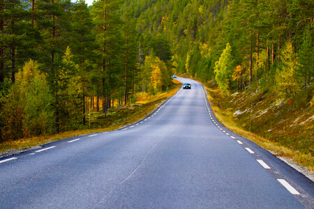Norwegian country road in the summer among the mountains photo
