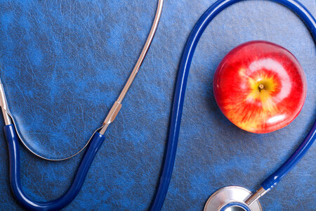 Stethoscope and red apple photo