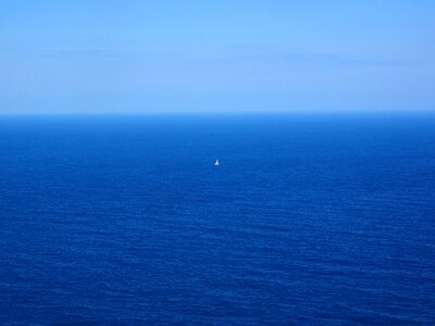 Blue water sailing boat photo