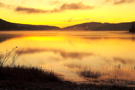 Fog and Mist over the lake landscape at Sunset photo
