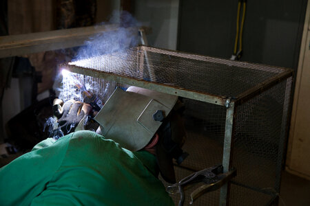 Service employee welds cages-2