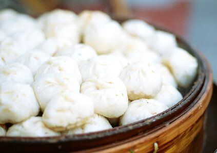 Street food booth selling Chinese specialty Steamed Dumplings photo