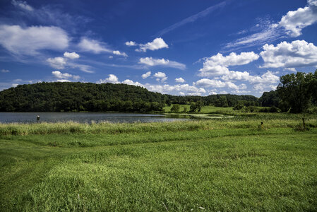 Landscape with blue sky and clouds with green grass at Indian lake photo