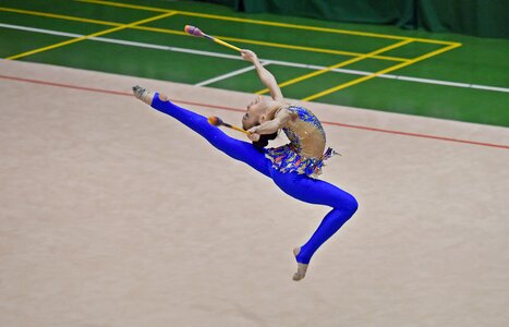 Beautiful rhythmic gymnast in professional arena photo