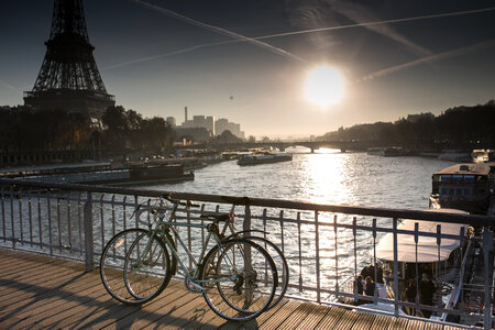Two Bicycles Standing on the Bridge next to the Eiffel Tower in Paris, France photo