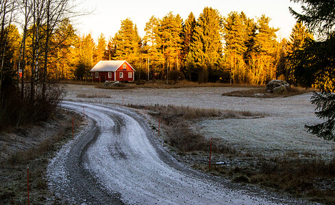 Farmhouse on snowy driveway landscape