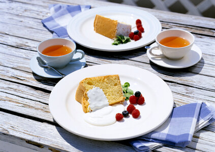 Victoria sponge cake with cream on wooden table photo