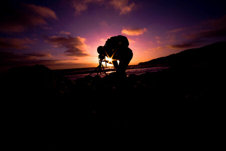 Photographer and His Camera on Tripod at Sunset. photo