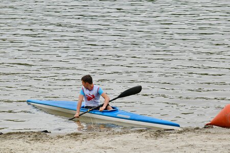 Athlete canoe riverbank photo
