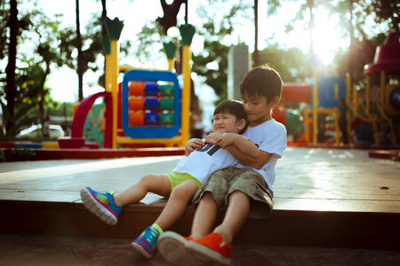 Two Asian Boys Playing Outdoors photo