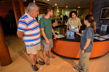 FWS Staff greets visitors at visitor center desk-1 photo
