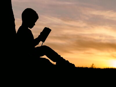 Silhouette Child Reading Sunset photo