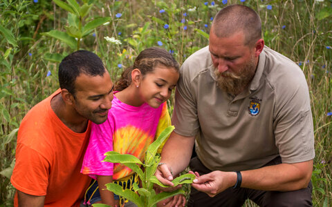 FWS employee shows a young girl (and dad) a Monarch caterpillar-2