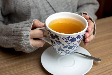 2 Female hands holding hot cup of tea photo
