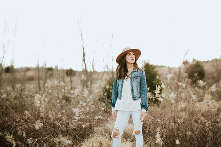 Brunette Woman Standing on a Meadow photo