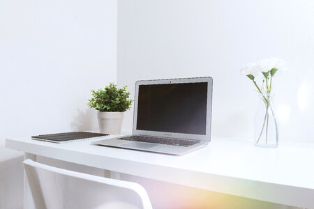 Modern white office interior with laptop photo