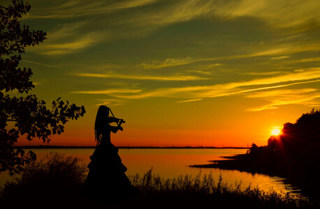 Violinist playing at sunset photo