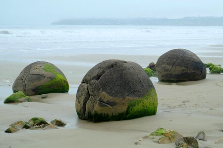Boulders and rocks on the shore on Koekohe beach, New Zealand photo