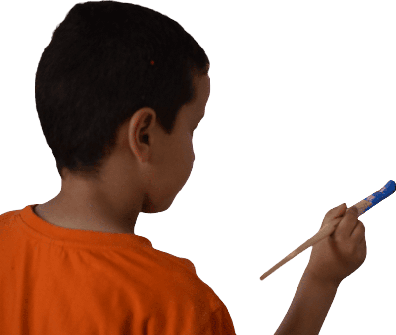 Back view of boy painting with brush