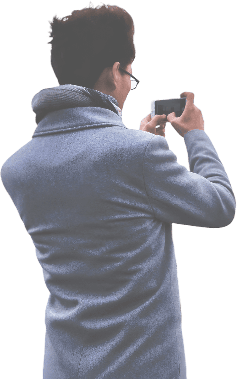 Man in blue coat using phone