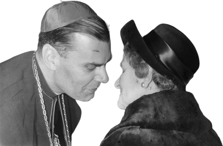 Woman Greeting Clergyman