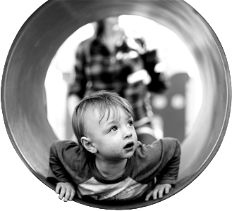 Grayscale photo of child in hole