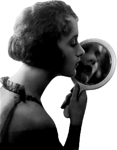 Constance talmadge head and shoulders portrait facing right looking into mirror