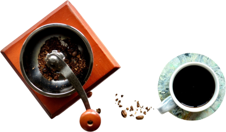 Hand grinder and full cup of coffee