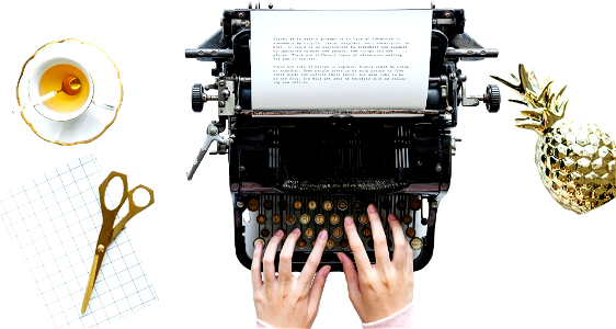 Hands typing on a antique typewriter
