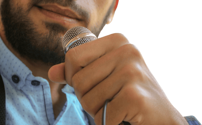 Close up photo of man holding microphone
