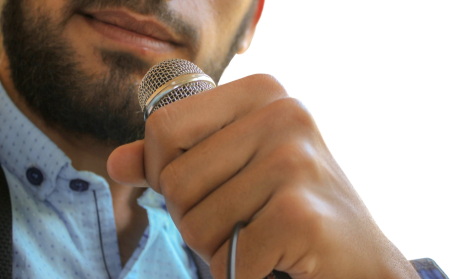 Close up photo of man holding microphone