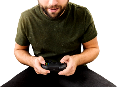 Close up of man eats popcorn holding joy stick and playing video games on tv at