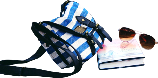 Blue and white striped crossbody bag near book and sunglasses on sea dock during