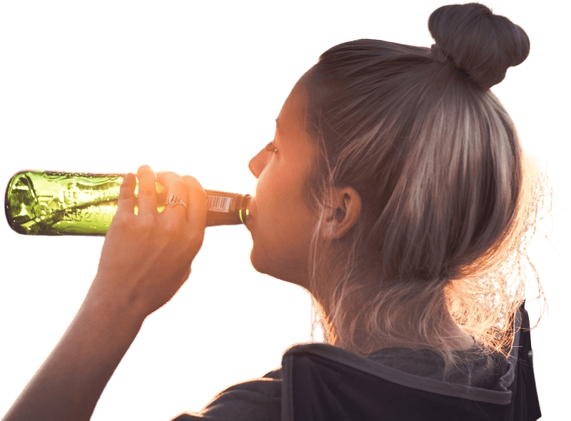 Girl drinking a beer at the sunset