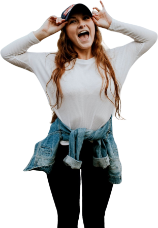Woman wearing black cap standing outside the house while laughing
